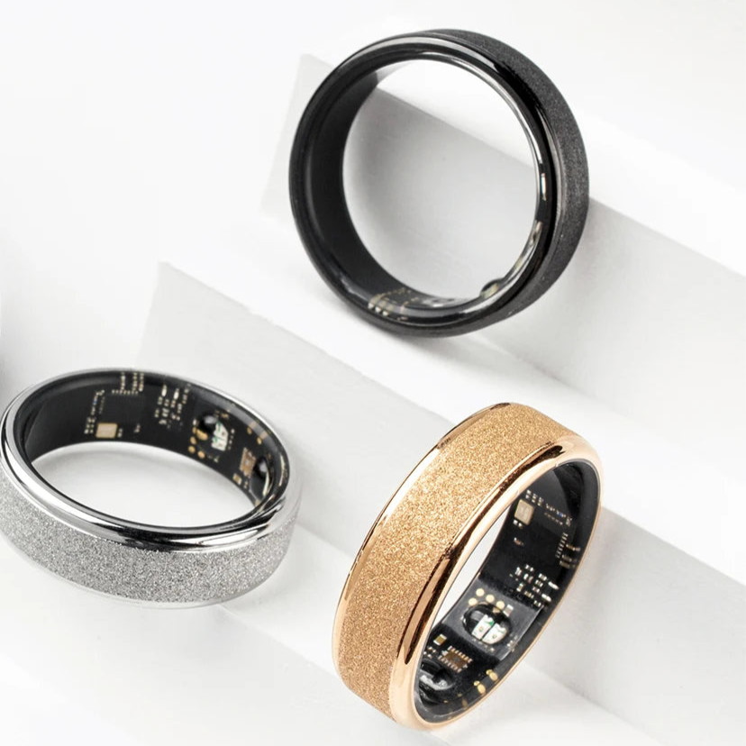 Three smart rings and a black case on a white background