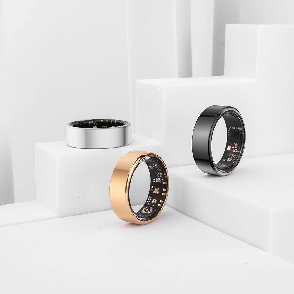 Three smart rings in gold, silver, and black on a white background