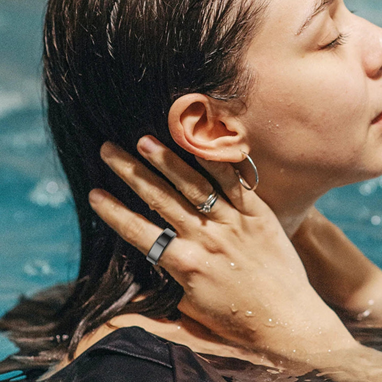 woman swimming with a sleek smart ring 