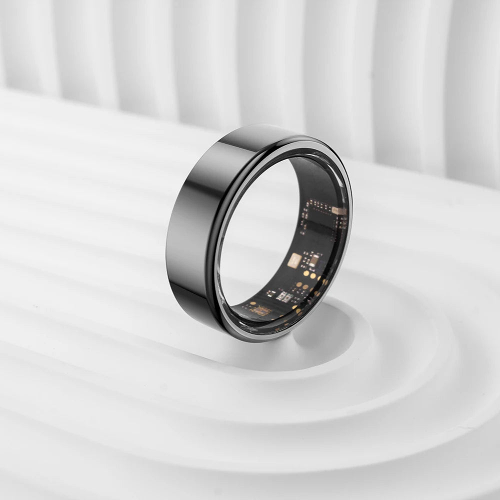 Smart ring on a white surface with a white curtain background
